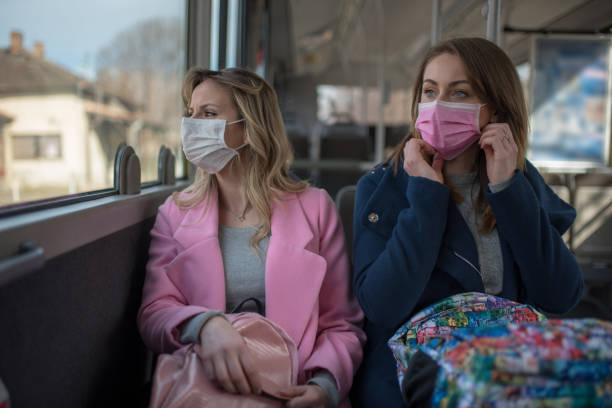 istock Two women at public transport during virus epidemic 1209960181