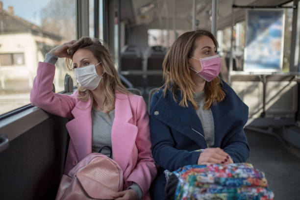 Two women at public transport during virus epidemic