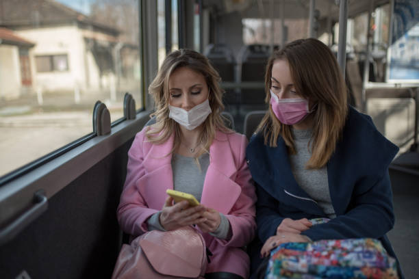 istock Two women at public transport during virus epidemic 1209960212