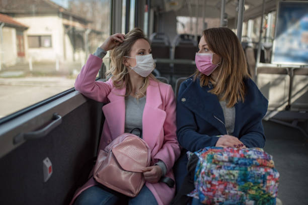 istock Two women at public transport during virus epidemic 1209960218
