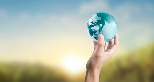 istock Globe ,earth in human hand, holding our planet glowing 1209963126