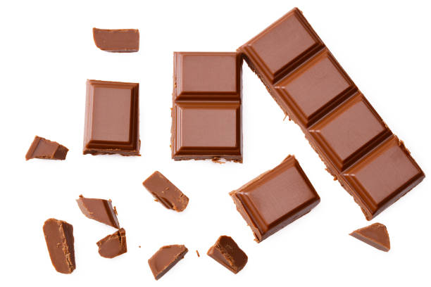 istock Milk chocolate pieces isolated on white background. top view 1209963964