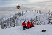 Search and Rescue are rescuing a man skier in the backcountry