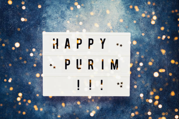 istock Purim celebration concept. Happy Purim written in light box on blue background. Top view, copy space. 1209965626