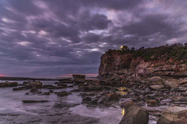 istock Moody Overcast and Rocky Dawn Seascape 1209965709