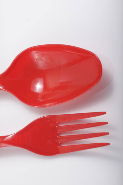 istock Red plastic cutlery on an isolated white background 1209965977