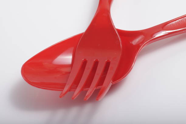 istock Red plastic cutlery on an isolated white background 1209966514