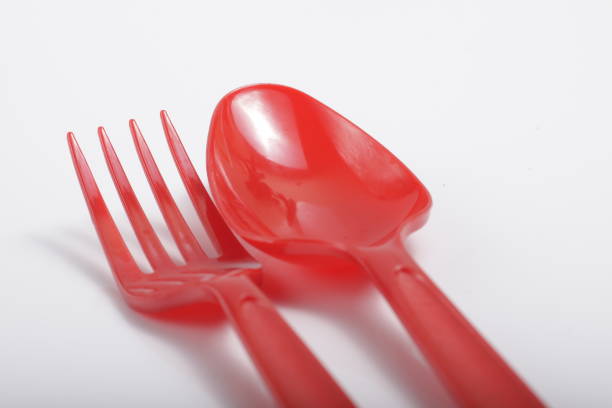 istock Red plastic cutlery on an isolated white background 1209966555