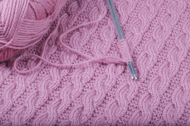 istock Pink woolen threads for knitting and knitting needles. 1209966642