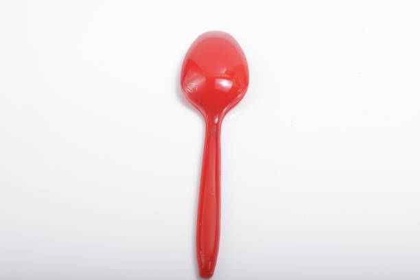 istock Red plastic cutlery on an isolated white background 1209967085