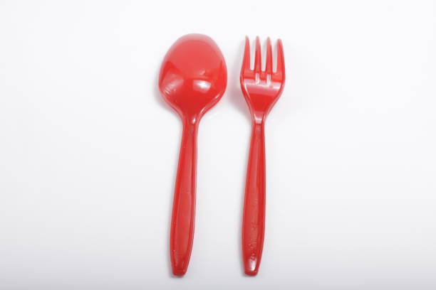 istock Red plastic cutlery on an isolated white background 1209967086