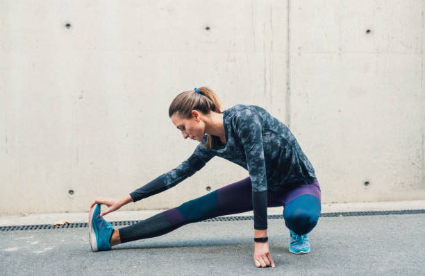 istock Sportswoman stretching outdoors 1209967217