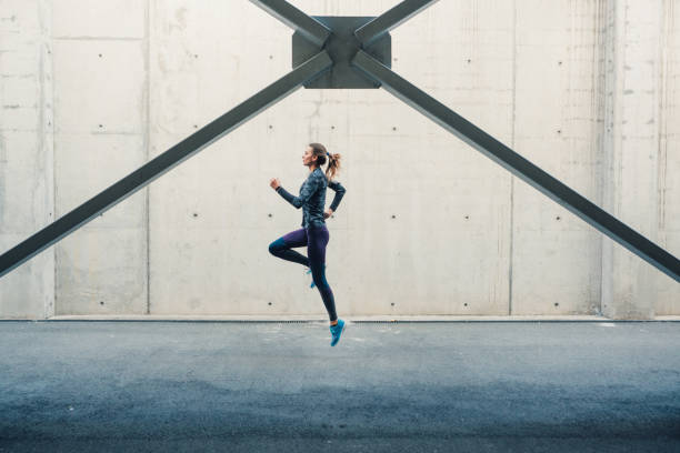 istock Sportswoman running outdoors 1209967220