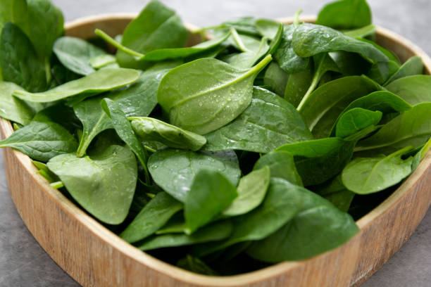 istock Fresh spinach leaves or spinach salad close up, background 1209967350