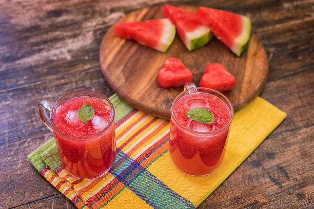 Fresh, cold blended watermelon juice in glass cups on table, close up, no people