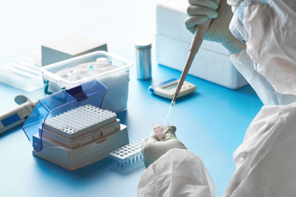 SARS-COV-2 pcr diagnostics kit. Epidemiologist in protective suit, mask and glasses works with patient swabs to detect specific region of 2019-nCoV virus causing Covid-19 viral pneumonia. Epidemiologist in protective suit, mask and glasses works with patient swabs to detect specific region of 2019-nCoV virus causing Covid-19 viral pneumonia. SARS-COV-2 pcr diagnostics kit concept. medical research photos stock pictures, royalty-free photos & images