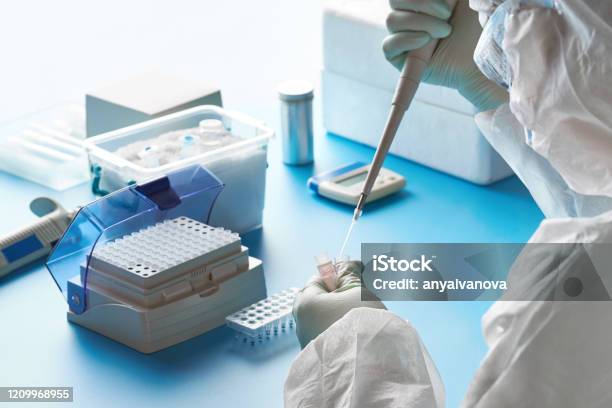 Sarscov2 Pcr Diagnostics Kit Epidemiologist In Protective Suit Mask And Glasses Works With Patient Swabs To Detect Specific Region Of 2019ncov Virus Causing Covid19 Viral Pneumonia Stock Photo - Download Image Now