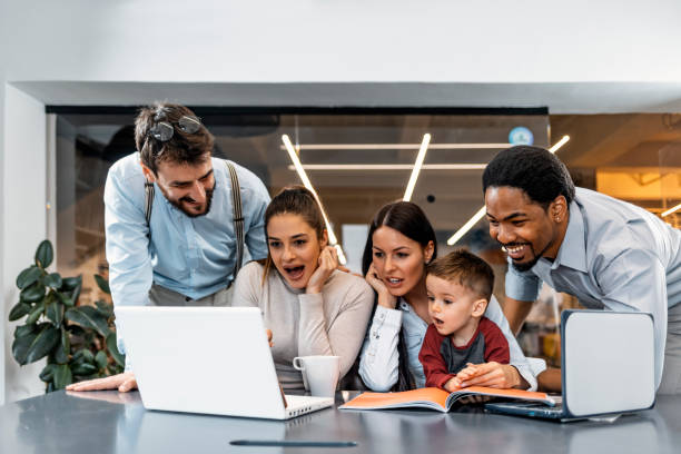 istock Female mentor teaching employees group analysing online project explaining strategy 1209969860
