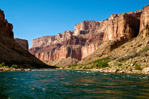 River rafters approach a rapid on the Colorado River in the Grand Canyon in Arizona on a sunny spring afternoon.