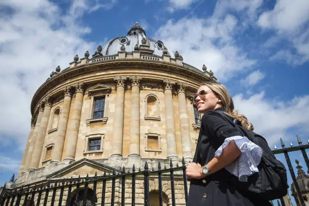 Female student walking around Oxford with her backpack