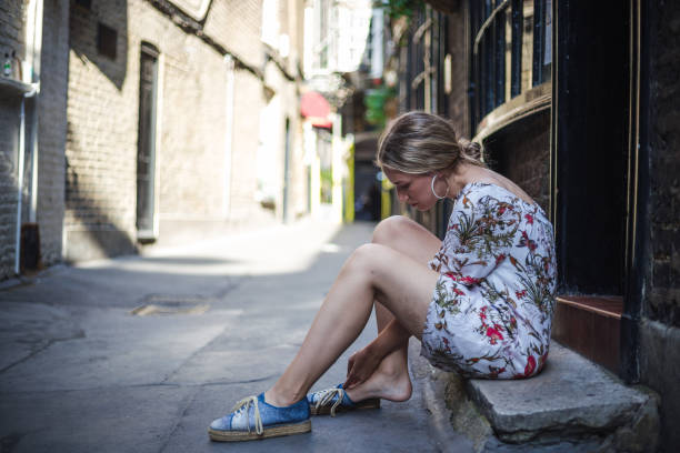 Woman relaxing on a stone bench in London