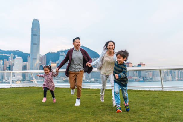 active chinese family at ocean terminal deck in hong kong - harbour city imagens e fotografias de stock