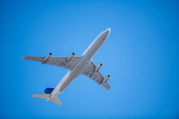 istock under belly of commercial passenger jet on cloudless blue sky 1209994408