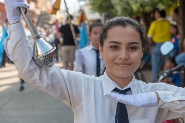 A teenager with a brass band baton happily celebrates August 7, an important day in Colombian history. San Alberto Cesar Colombia August 7, 2019.