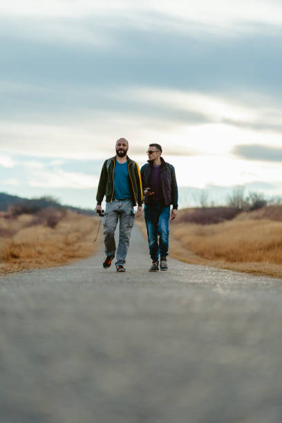 Friends hiking down the road