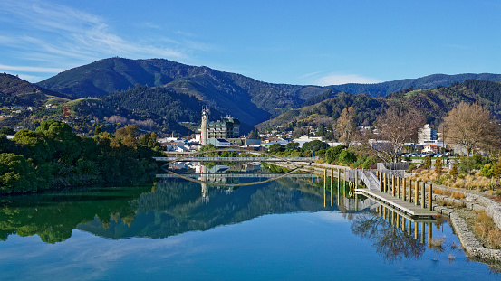 Panorama of Nelson City, reflected in the still waters of the Maitai River, New Zealand.