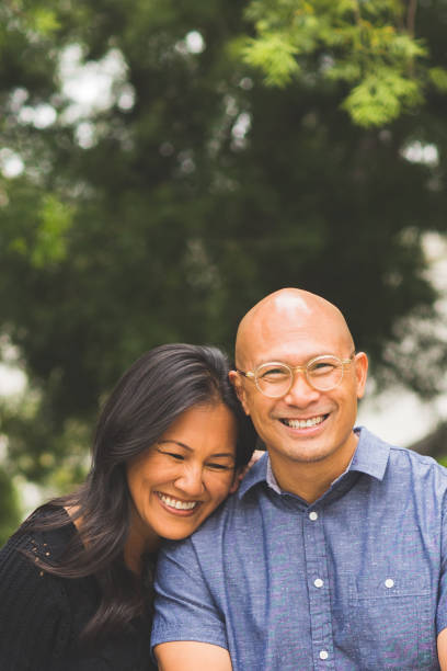 istock Happy Asian couple smiling and hugging outside. 1209996145