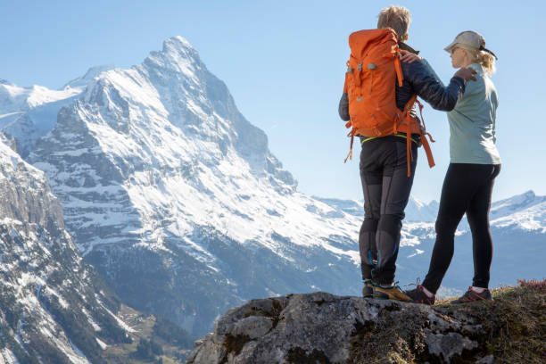 istock Hiking couple ascend alpine slope, in mountains 1209996267