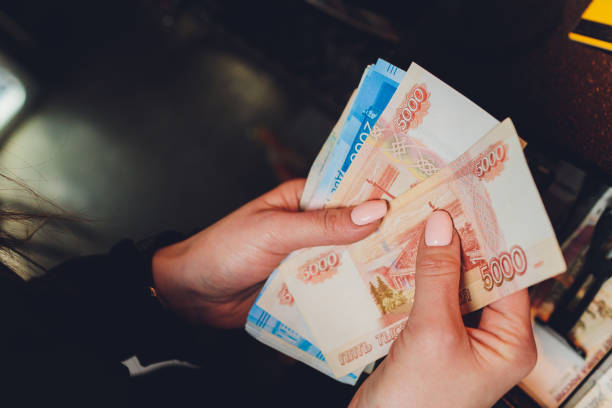 Female hands holding Russian banknotes of one thousand rubles. stock photo