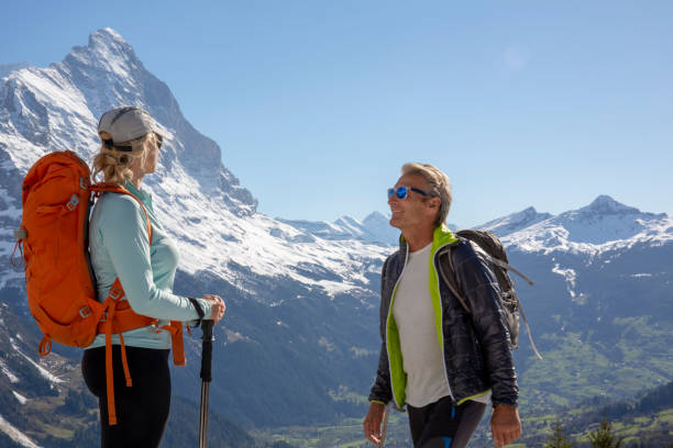 istock Hiking couple ascend alpine slope, in mountains 1209996294