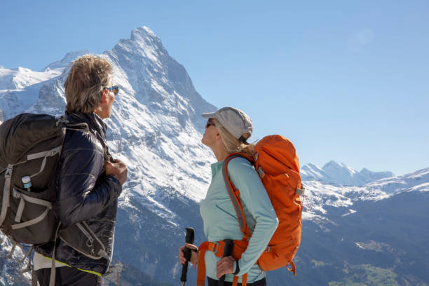 istock Hiking couple ascend alpine slope, in mountains 1209996301