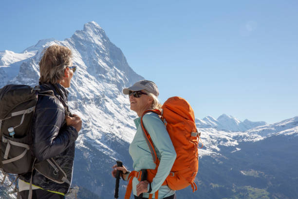 istock Hiking couple ascend alpine slope, in mountains 1209996321