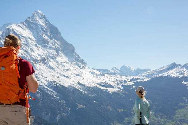 istock Hikers ascend slope, in mountains 1209996333
