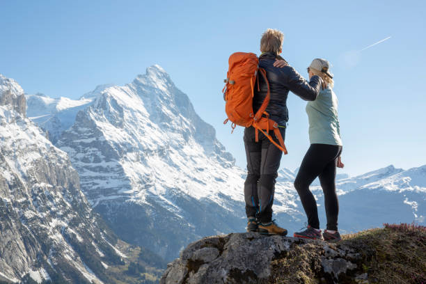 istock Hiking couple ascend alpine slope, in mountains 1209996421
