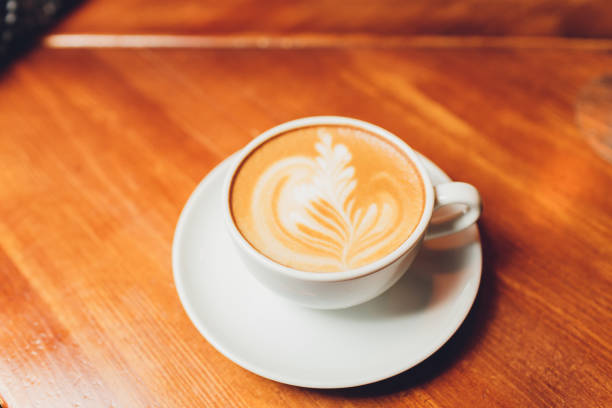 istock hot milk art coffee on wooden table. 1209996440