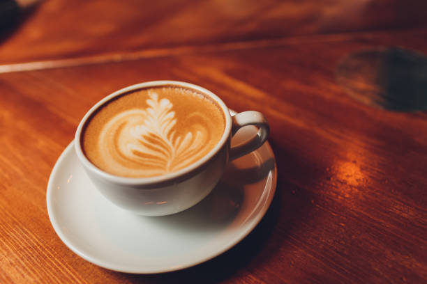 istock hot milk art coffee on wooden table. 1209996456