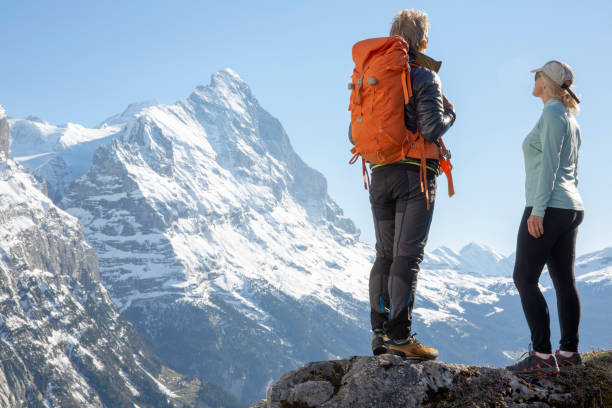 istock Hiking couple ascend alpine slope, in mountains 1209996509