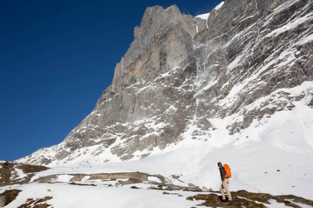 istock Male hiker ascends snowslope, in mountains 1209996581
