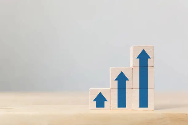 Photo of Ladder career path for business growth success process concept.Wooden block stacking as step stair with arrow up