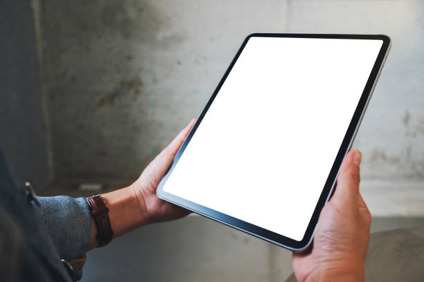 istock a woman holding black tablet pc with blank white screen in cafe 1209999326
