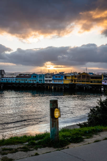 восход солнца со старой рыбацкой пристани - monterey california monterey county cannery row стоковые фото и изображения