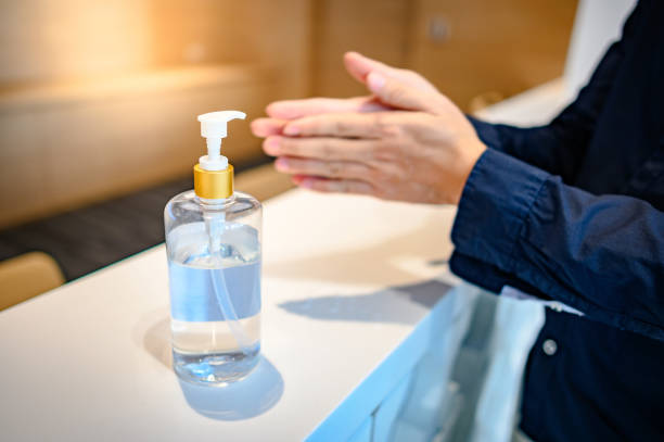 Washing hands by alcohol sanitizers from bottle