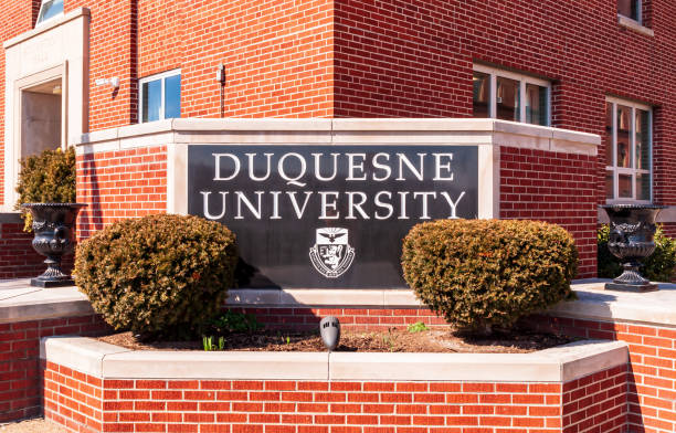 The Duquesne University sign on campus on a sunny winter day, Pittsburgh, Pennsylvania, USA stock photo