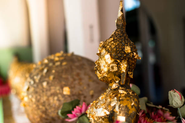 Gilding on buddha statue in Thai Temple Thailand,gold sheet on face buddha statue in thailand temple,Gold sheet gilding.