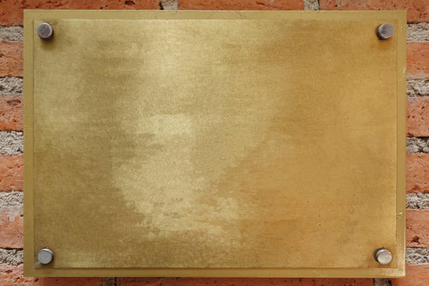 istock Brass or bronze metal plate on brick wall background 1210012216