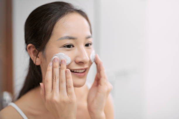 istock Happy beautiful lady cleaning her face with soap in bathroom 1210013873